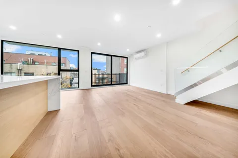 a view of an empty room with a kitchen