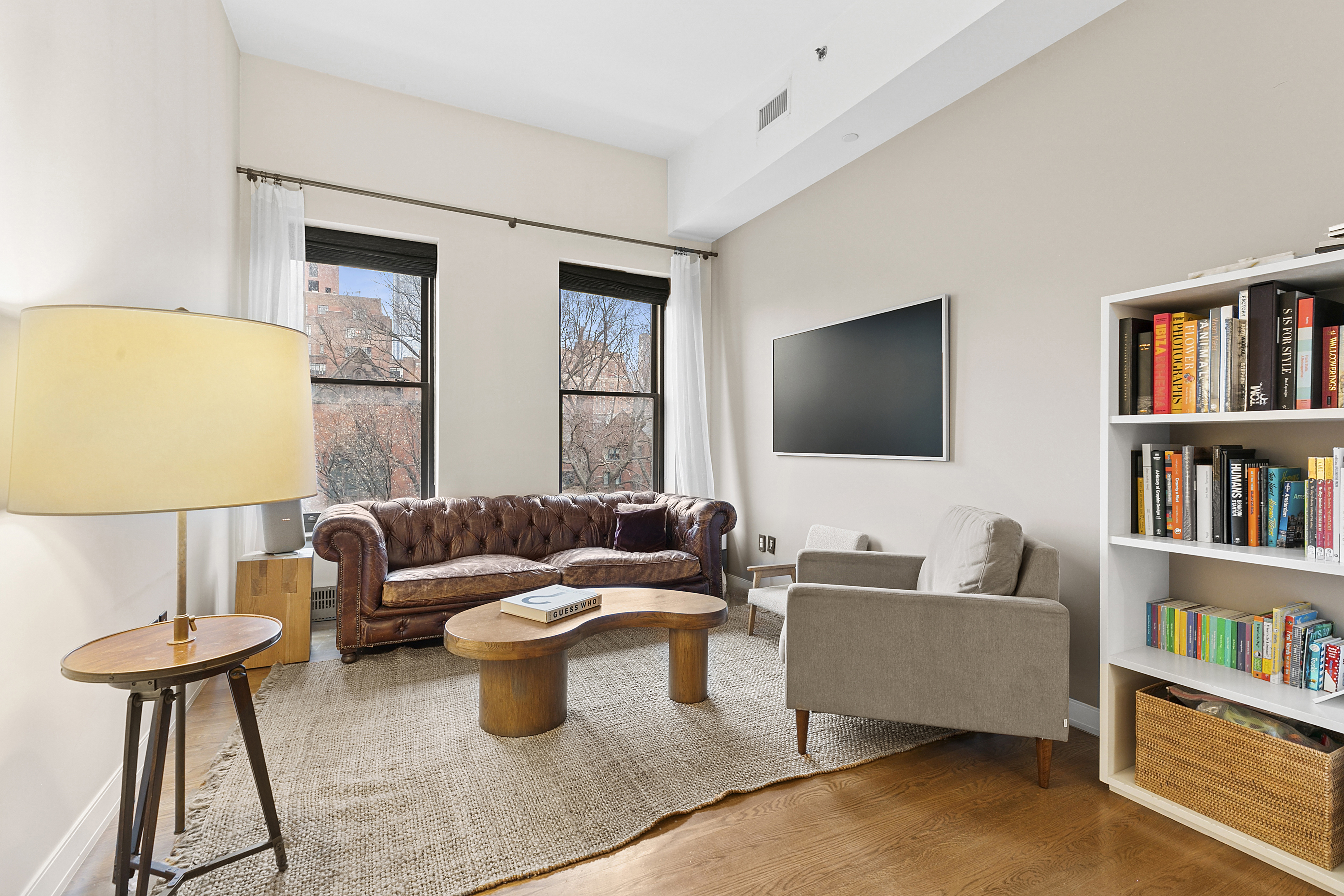 422 West 20th Street, Unit 5A Manhattan, NY 10011 - Photo 2 of 14 a living room with furniture and a flat screen tv
