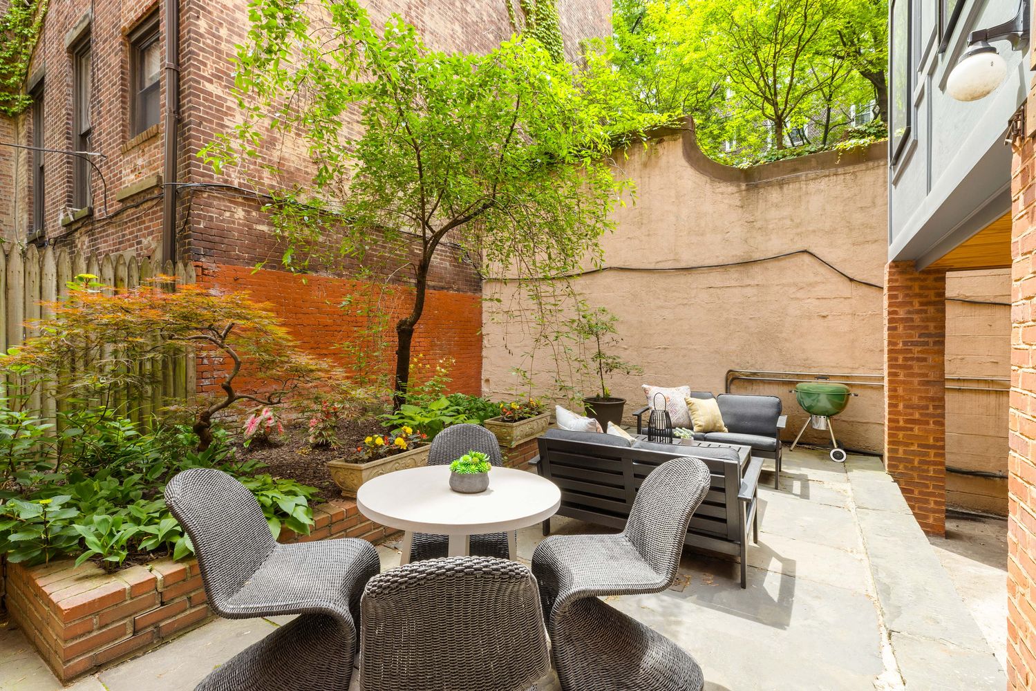 a outdoor space with patio the couches and a potted plant on a table and chairs