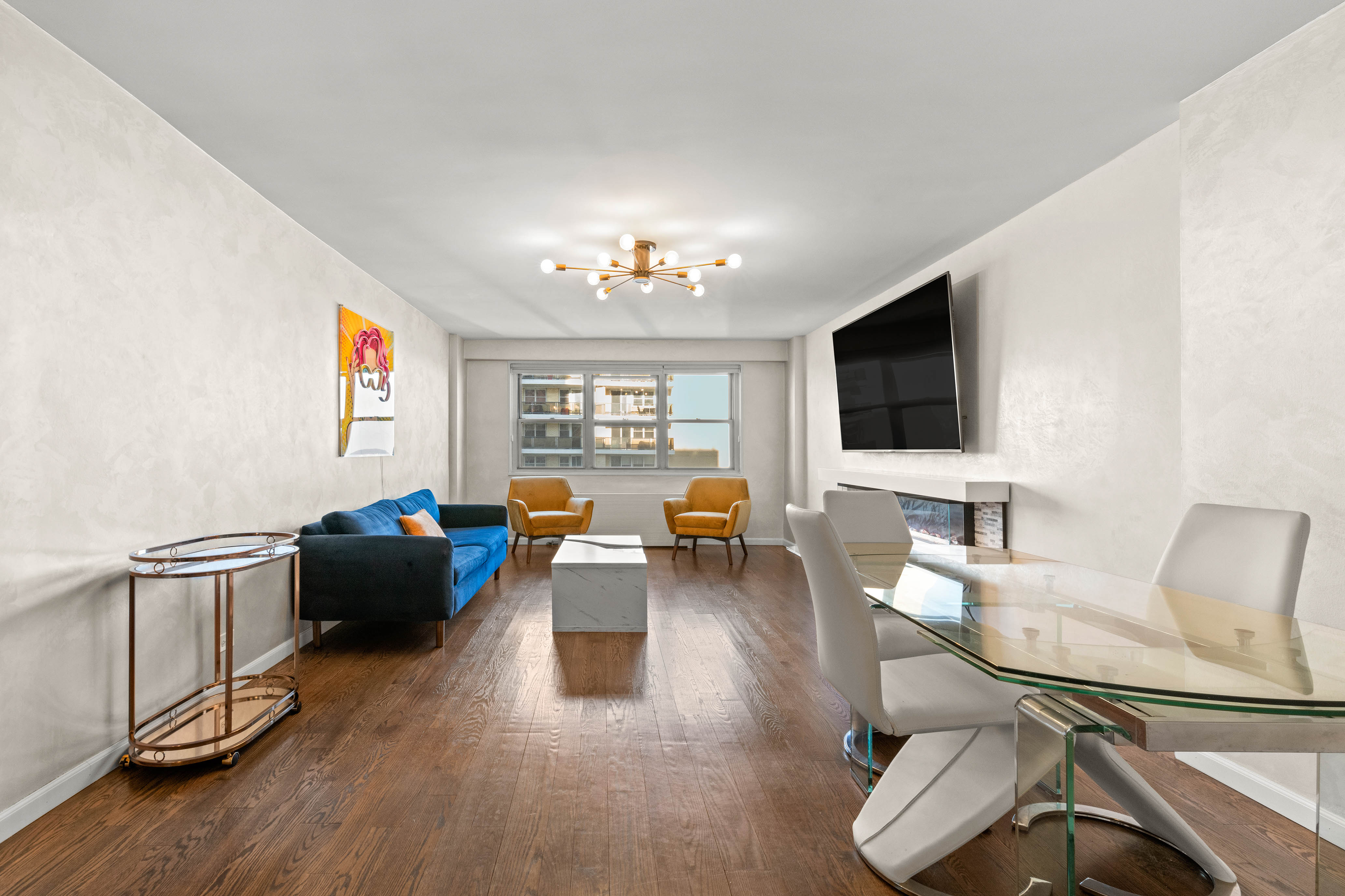 102-10 66th Road, Unit K25 Queens, NY 11375 - Photo 3 of 19 a living room with furniture and a flat screen tv