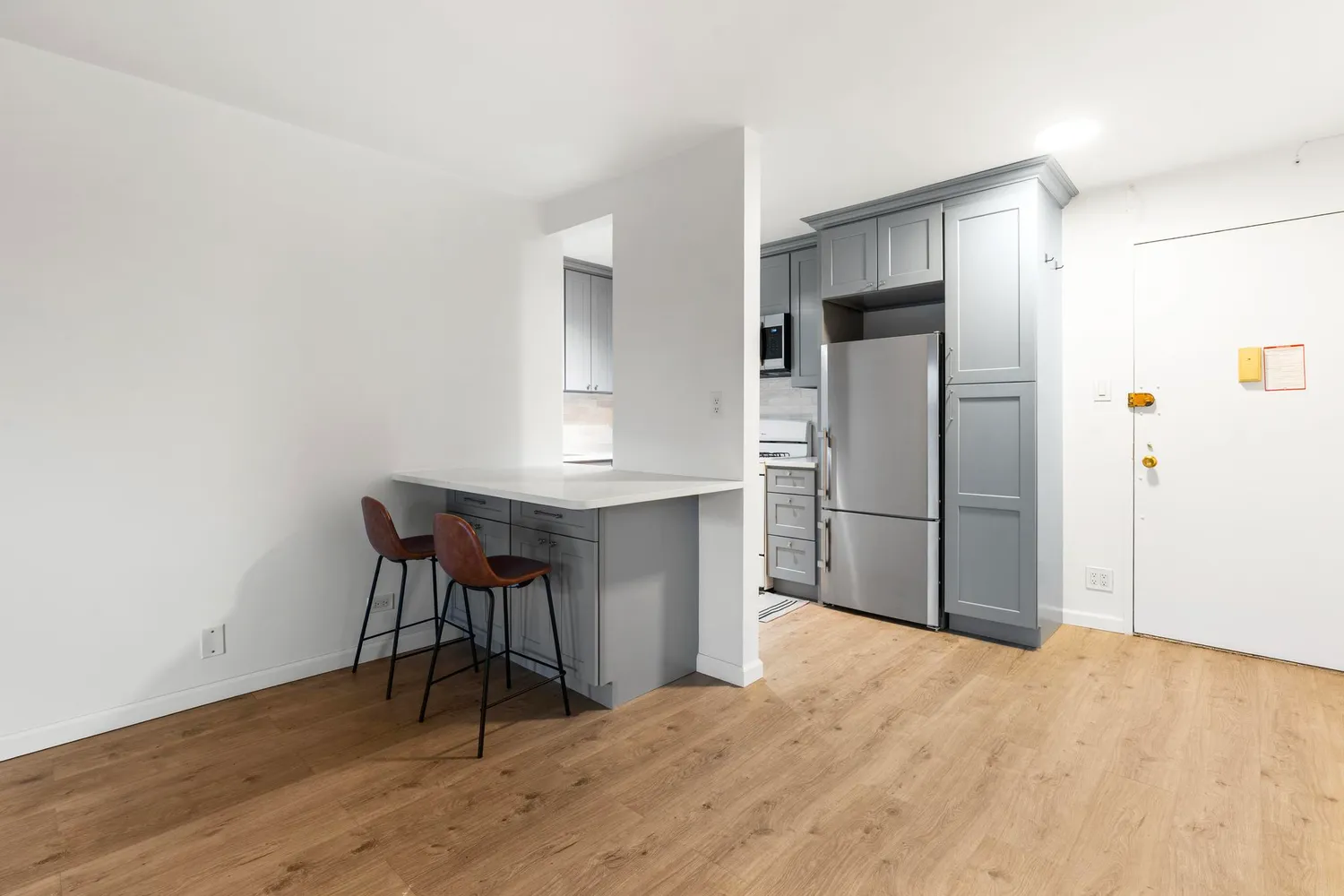 a kitchen with stainless steel appliances a refrigerator and a table