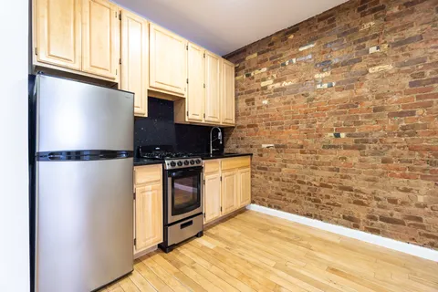 a kitchen with stainless steel appliances a refrigerator and a stove top oven