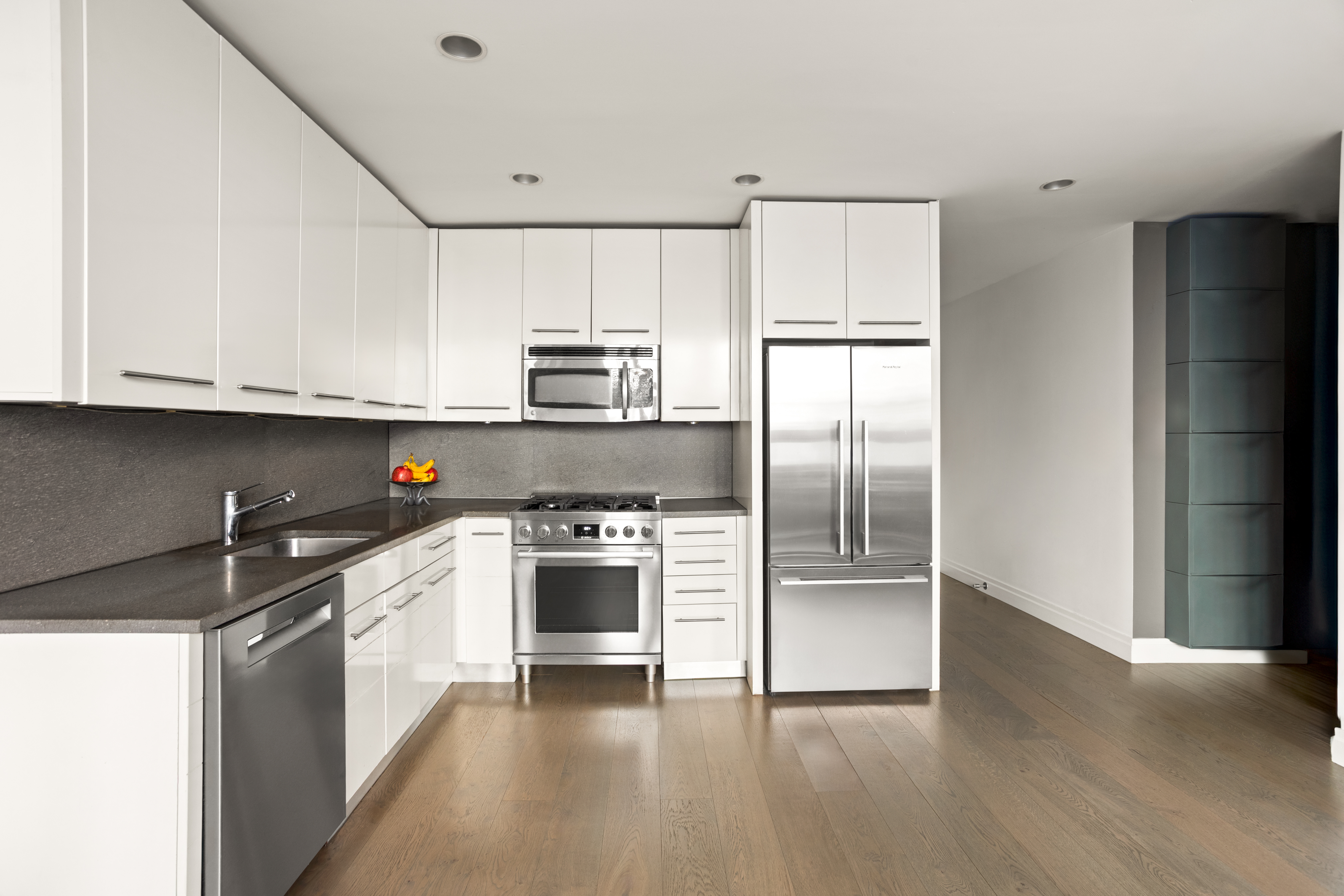 517 West 46th Street, Unit 205 Manhattan, NY 10036 - Photo 3 of 6 a kitchen with stainless steel appliances granite countertop a refrigerator sink and stove