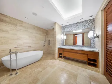 a bathroom with a tub sink and mirror