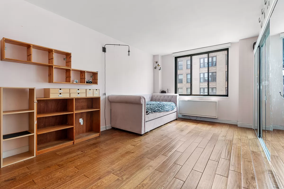108 5th Avenue, Unit 15C Manhattan, NY 10011 - Photo 4 of 12 a living room with hard wood floors and furniture