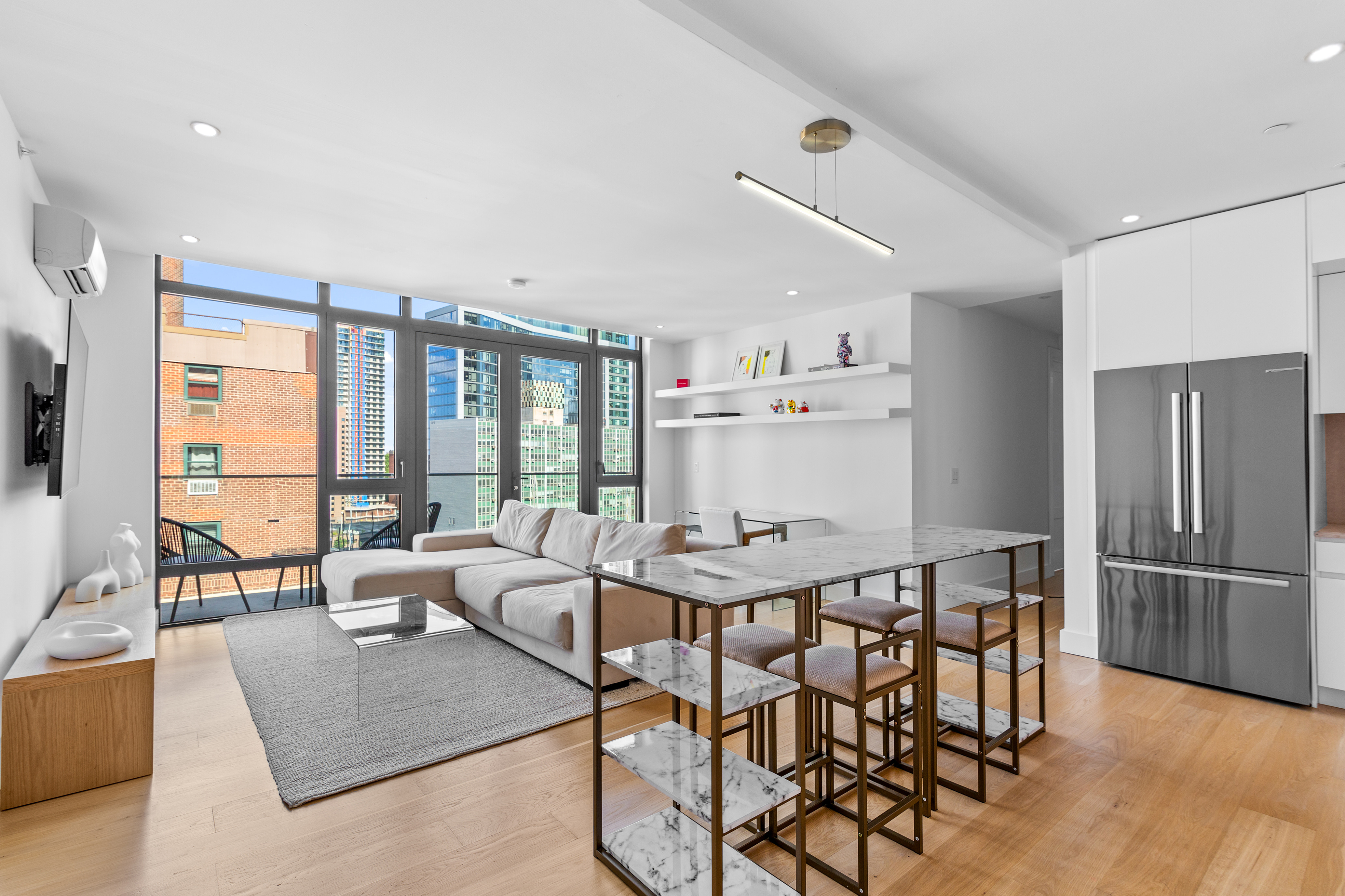 112 Fleet Place, Unit 12A Brooklyn, NY 11201 - Photo 2 of 15 a view of a dining room with furniture large windows and wooden floor