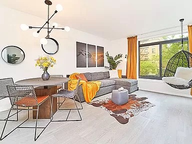 2351 Adam Clayton Powell Jr Boulevard, Unit 306 Manhattan, NY 10030 - Photo 1 of 13 a living room with patio furniture and a large window