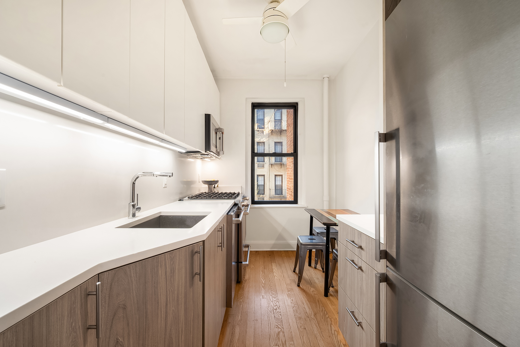 305 East 88th Street, Unit 3E Manhattan, NY 10128 - Photo 4 of 9 a kitchen with a sink stove and refrigerator