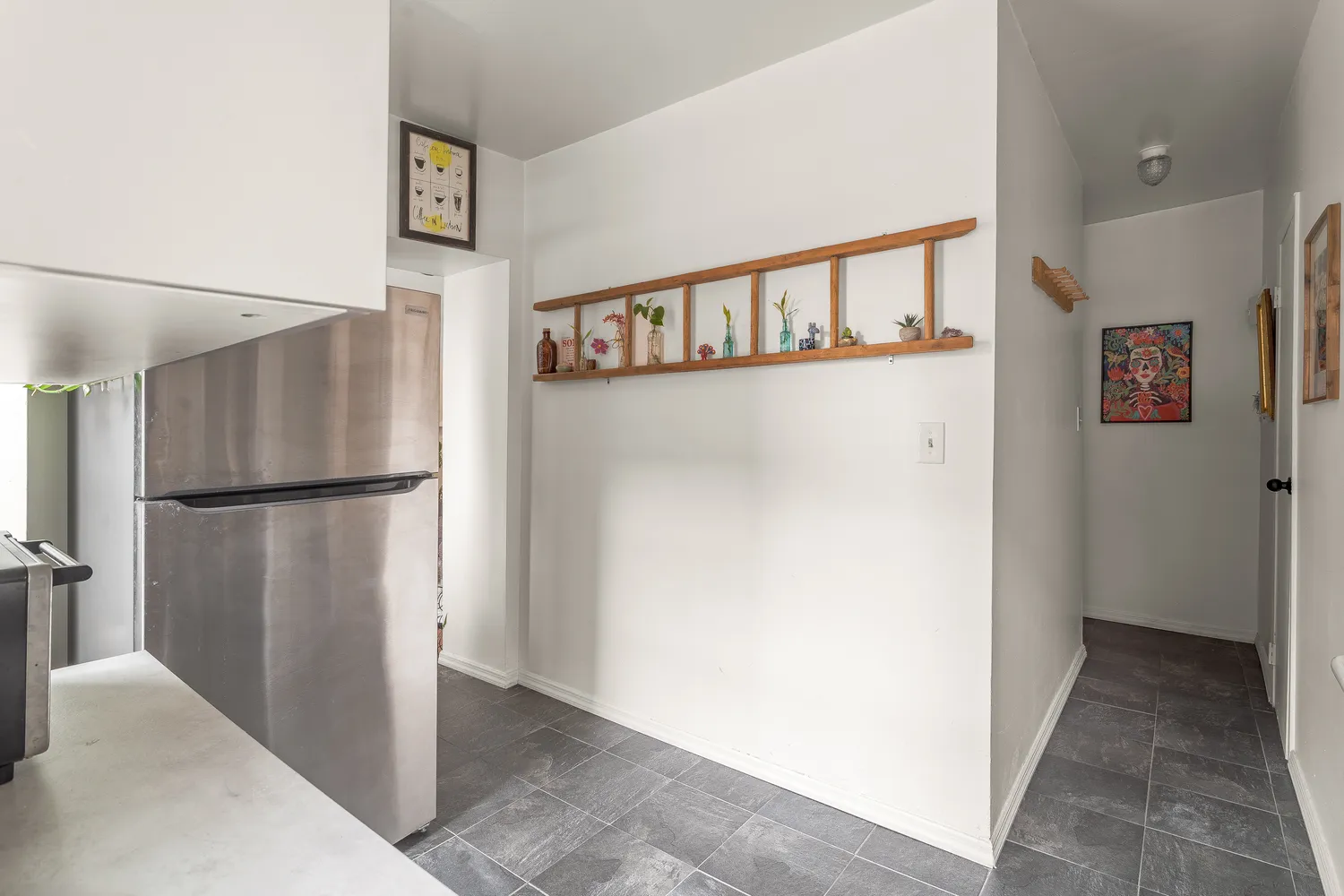 a view of a hallway with a refrigerator