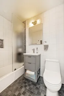 a bathroom with a sink toilet and shower