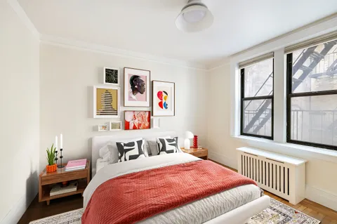 a bedroom with bed and windows