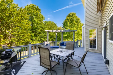 a patio with wooden floor and outdoor seating