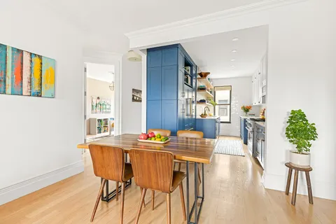 a dining room with furniture and wooden floor