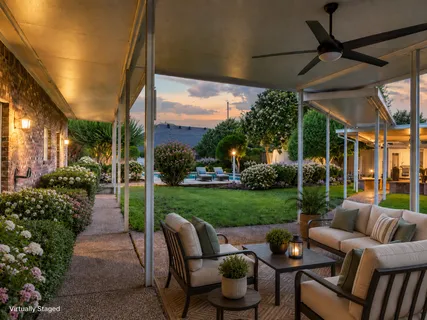 a view of a patio with couches table chairs and potted plants