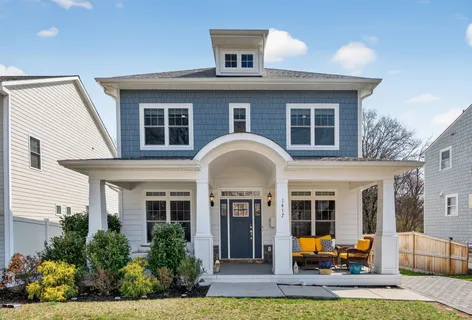 a view of a house with a porch and furniture
