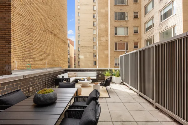 a view of balcony with couch and chairs