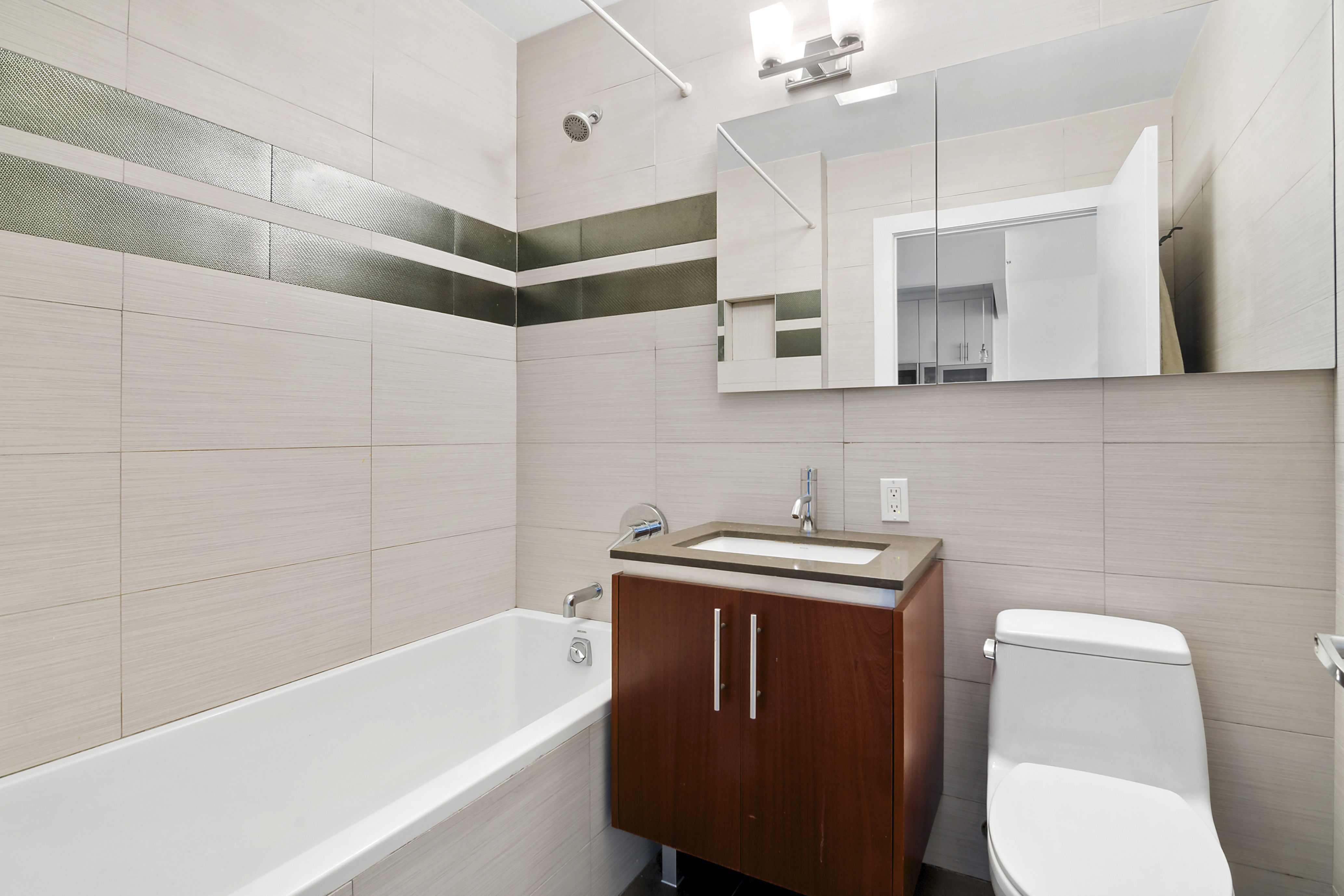 41-18 27th Street, Unit 4A Queens, NY 11101 - Photo 4 of 5 a bathroom with a sink toilet and shower