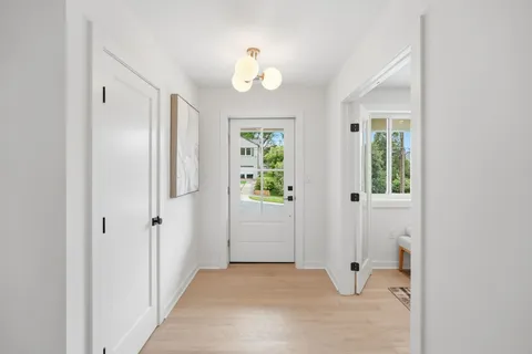 a picture of a room with a white wall and a window