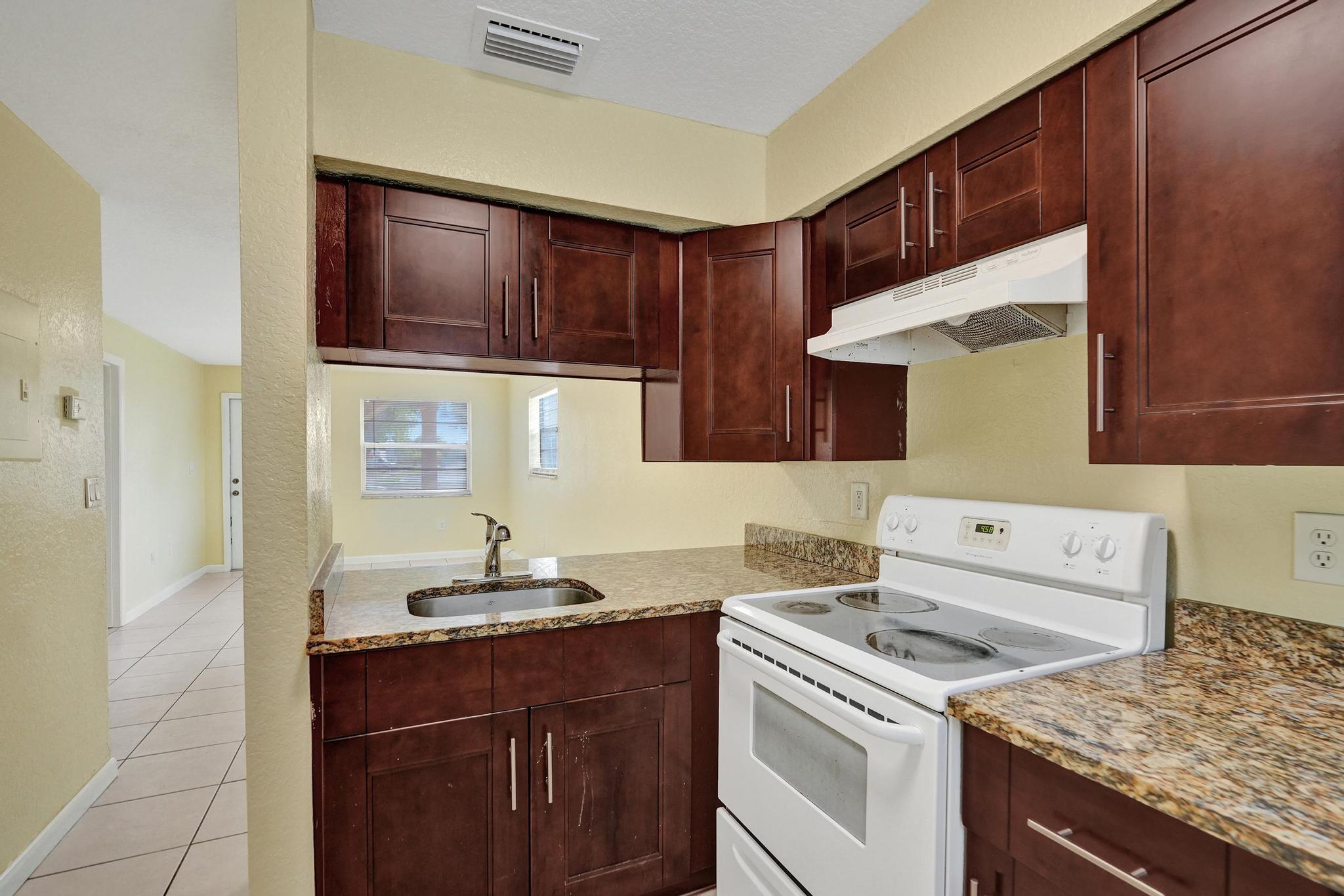 1101 Prospect Road Fort Lauderdale, FL 33309 - Photo 20 of 34 a kitchen with a sink stove and cabinets