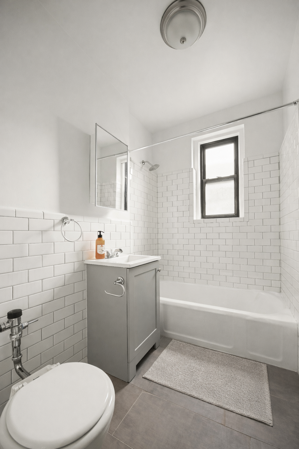 385 East 18th Street, Unit 4E Brooklyn, NY 11226 - Photo 5 of 7 a bathroom with a sink a toilet and shower