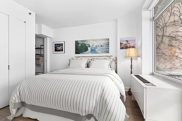 425 East 13th Street, Unit 2A Manhattan, NY 10009 - Photo 3 of 7 a bedroom with double bed and a window