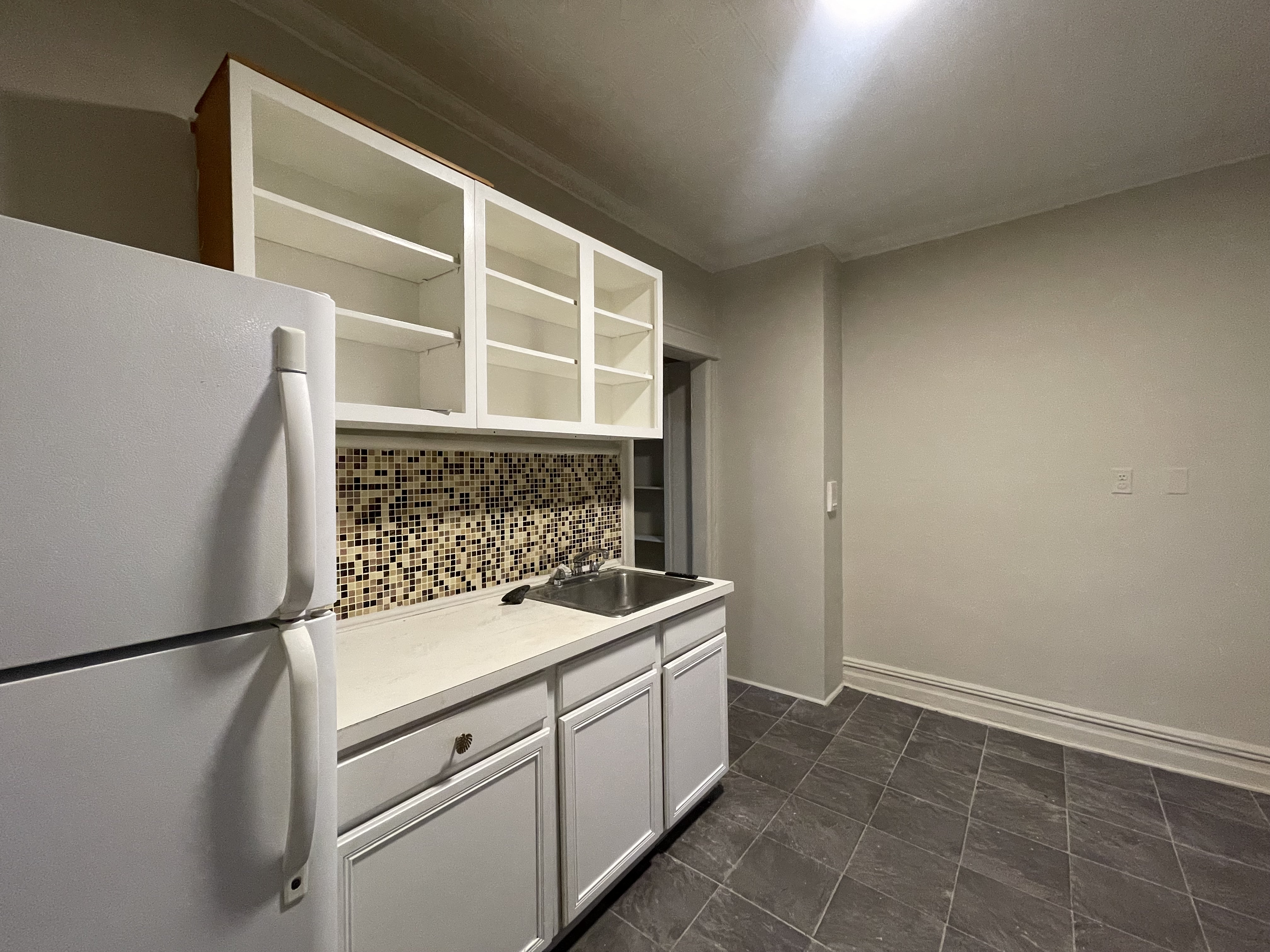 68-43 Fresh Pond Road, Unit 2R Queens, NY 11385 - Photo 5 of 6 a kitchen with a stove and a refrigerator