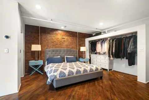 a bedroom with a bed window and walk in closet