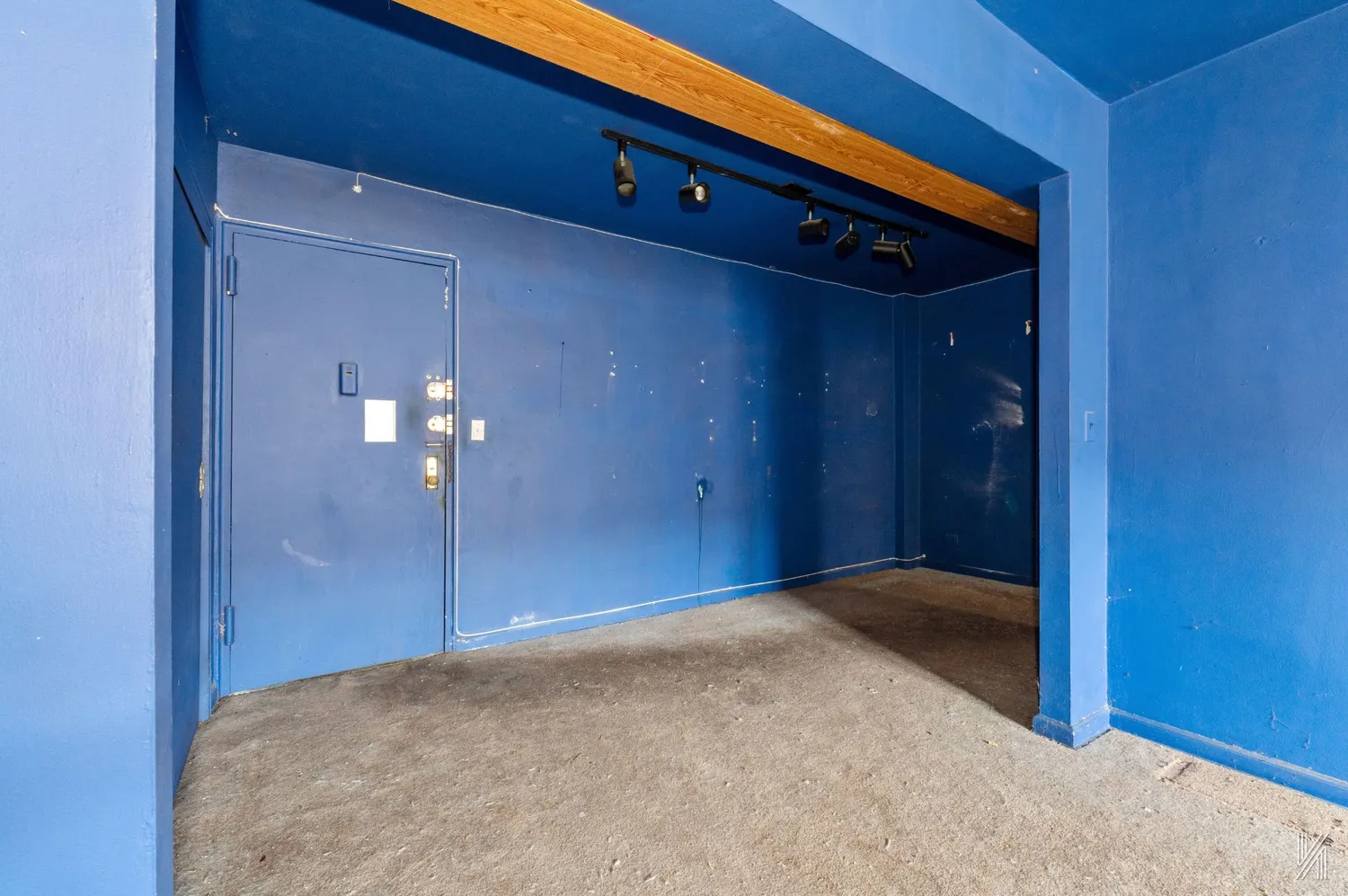 a view of a kitchen with refrigerator and wooden cabinets
