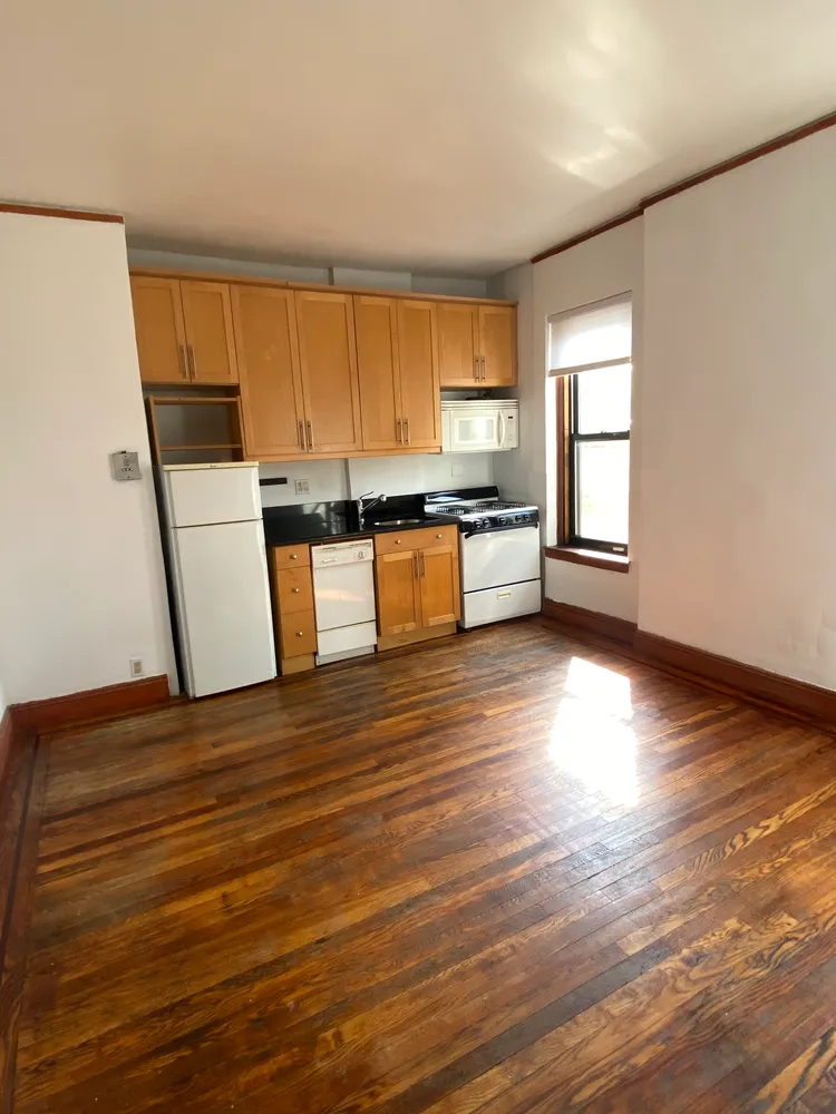 a view of kitchen and wooden floor