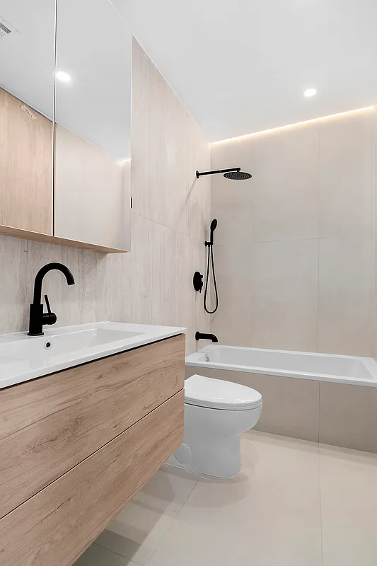 496 Wilson Avenue, Unit 4A Brooklyn, NY 11221 - Photo 6 of 10 a bathroom with a sink a toilet and a bathtub