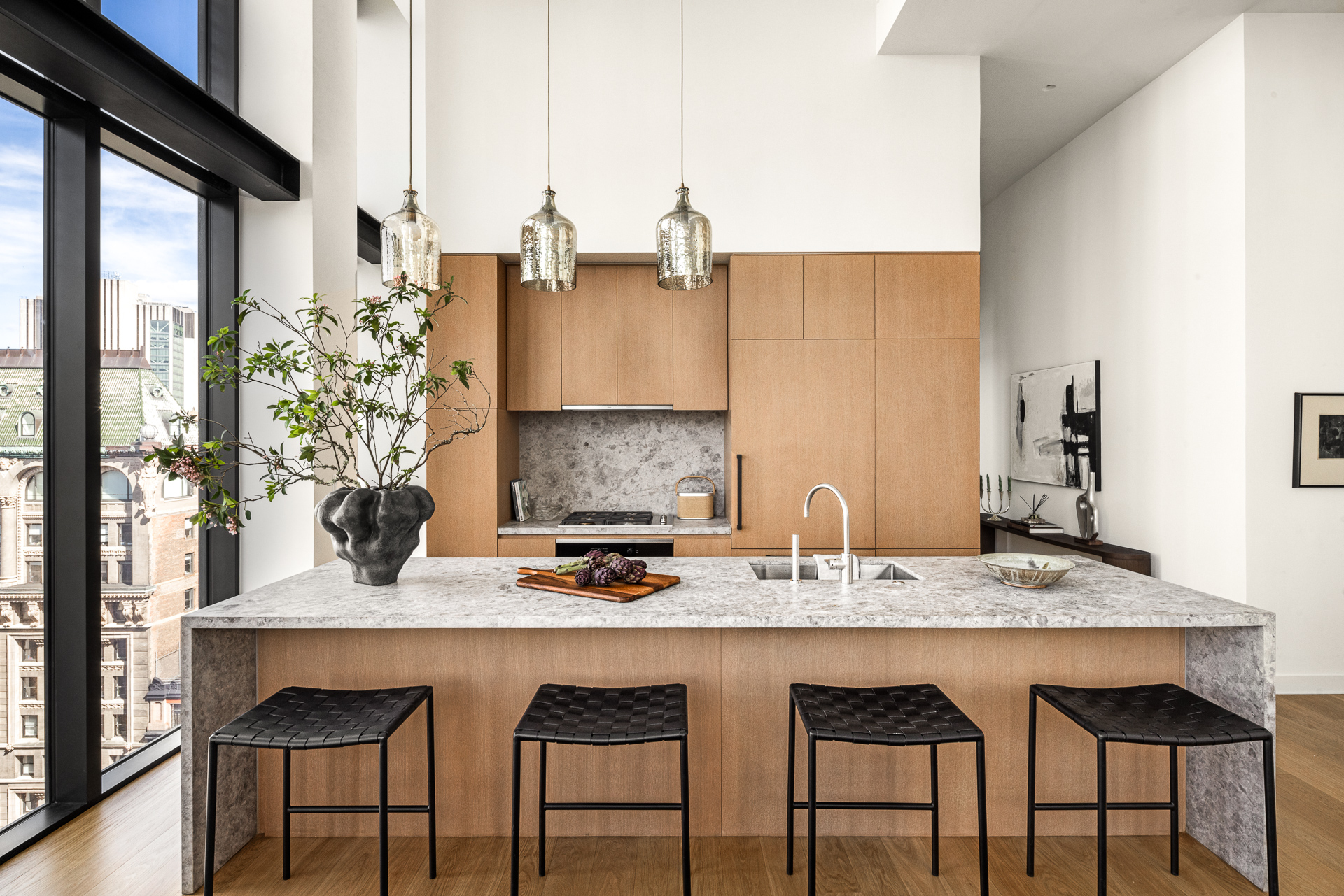 33 Park Row, Unit PH1 Manhattan, NY 10038 - Photo 6 of 15 a kitchen with a granite countertop sink table and chairs