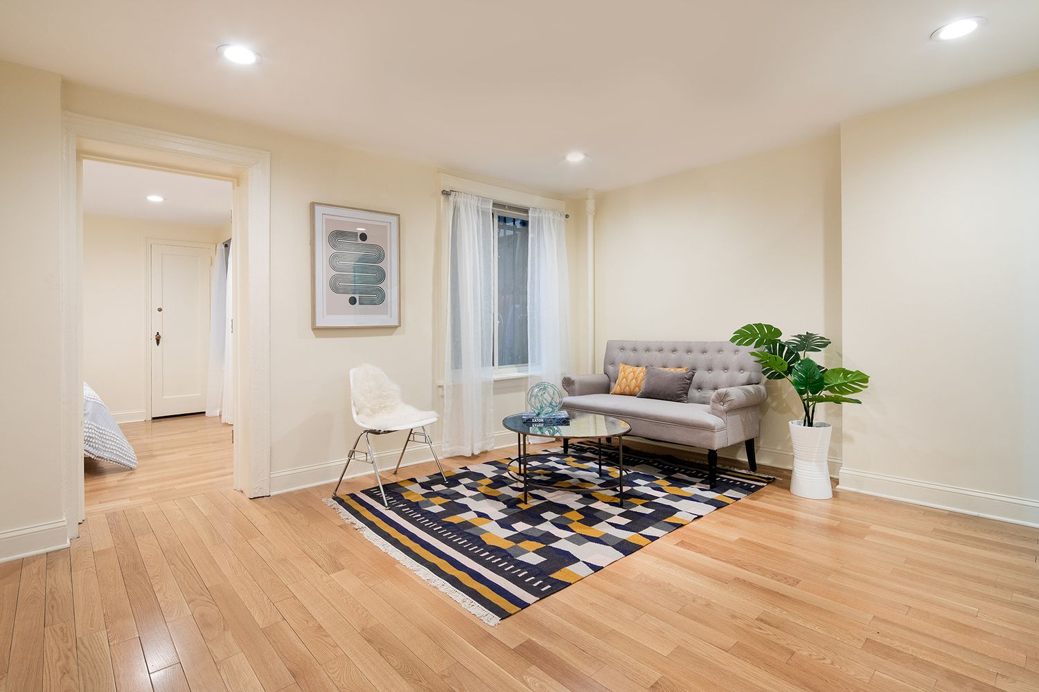 131 East 15th Street, Unit 1BC Manhattan, NY 10003 - Photo 1 of 10 a living room with furniture and a potted plant