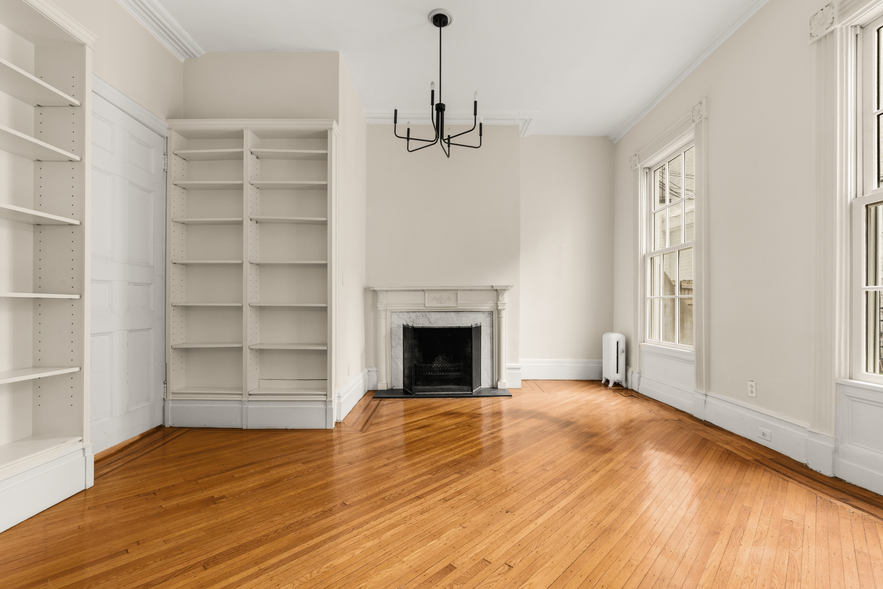 60 Hicks Street Brooklyn, NY 11201 - Photo 3 of 22 a view of an empty room with a fireplace and a window