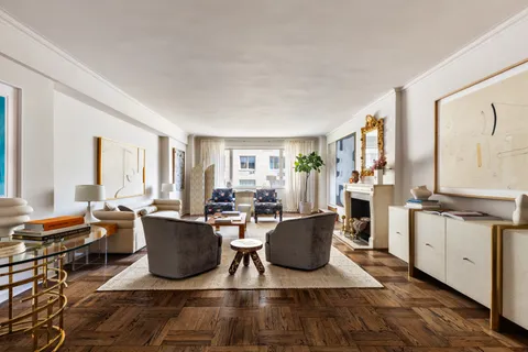 a living room with fireplace furniture and a window