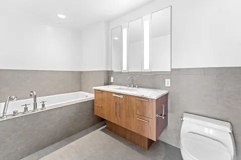 a bathroom with a bathtub sink and toilet