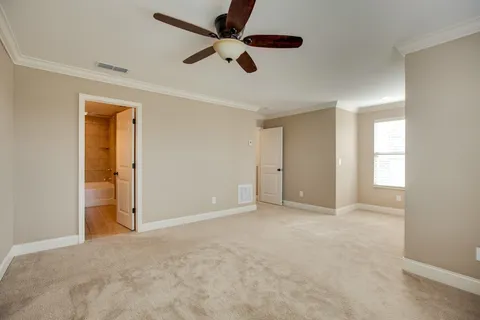 wooden floor in an empty room and a ceiling fan