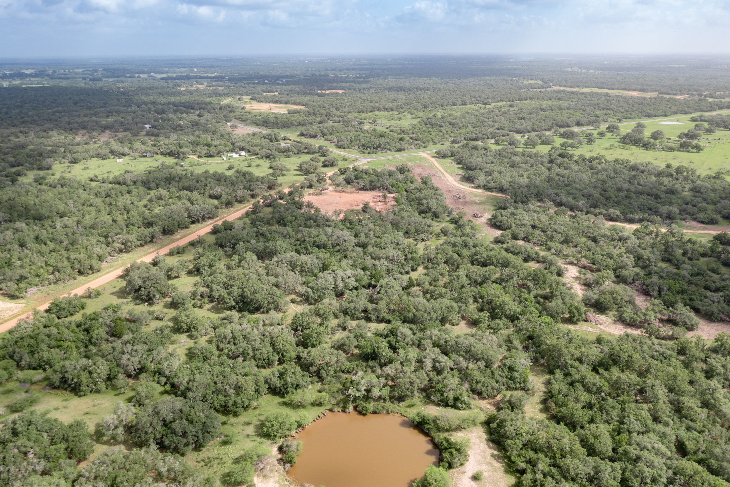 54.68 Cattle Guard Road Cuero, TX 77954 - Photo 5 of 67 an aerial view of residential houses with outdoor space and trees