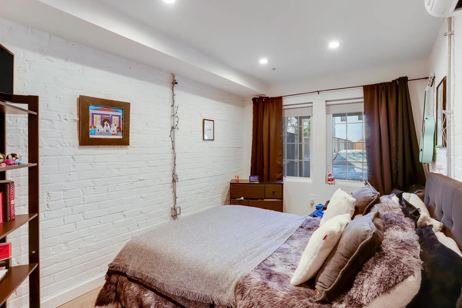 a bedroom with a bed and a television