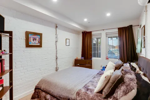 a bedroom with a bed and a television