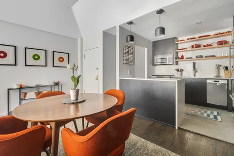 a dining room with furniture a window and appliances
