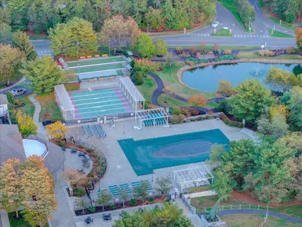 an aerial view of a swimming pool patio and outdoor seating
