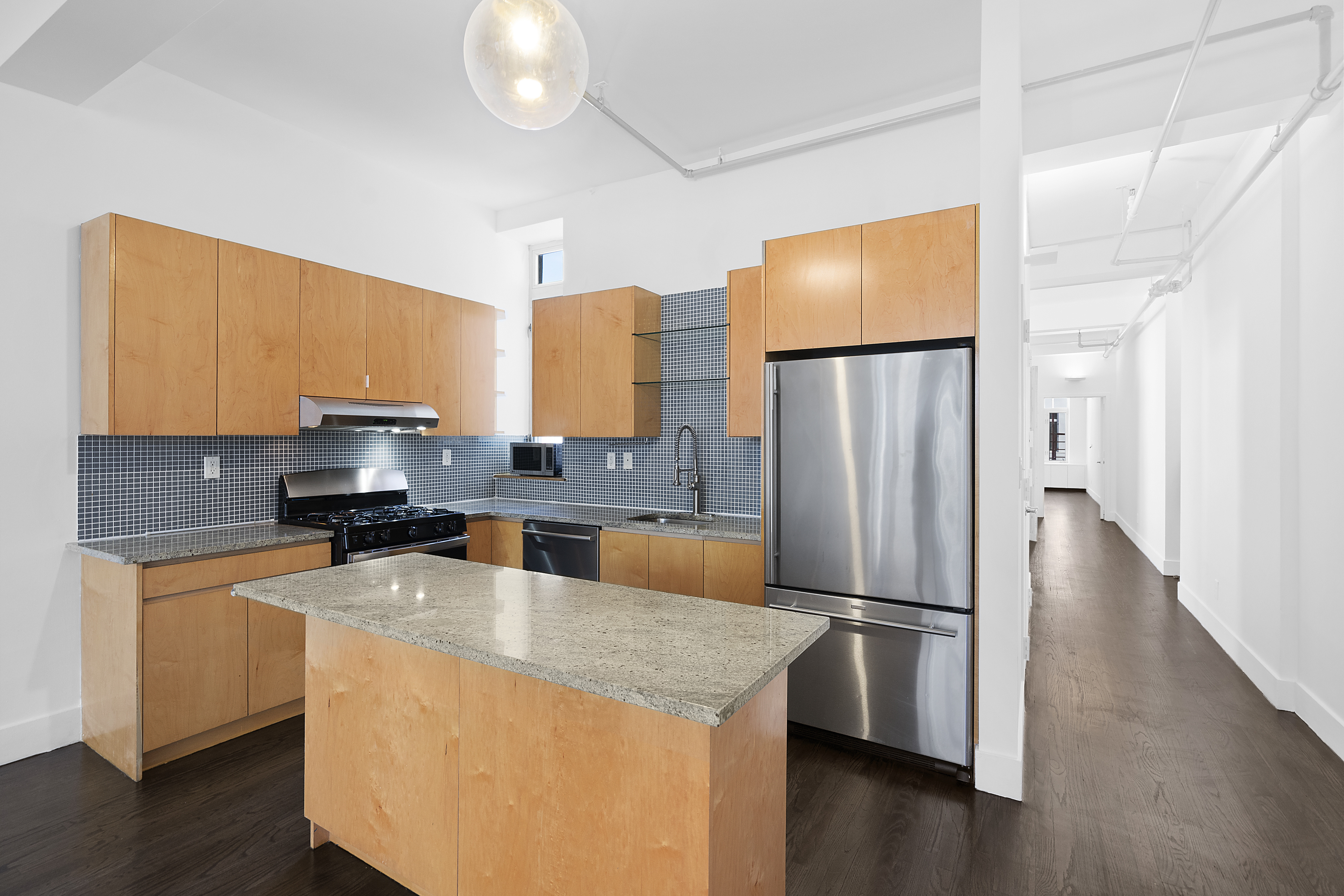 91 Grand Avenue, Unit 2D Brooklyn, NY 11205 - Photo 4 of 16 a kitchen with stainless steel appliances granite countertop a refrigerator a stove and a sink
