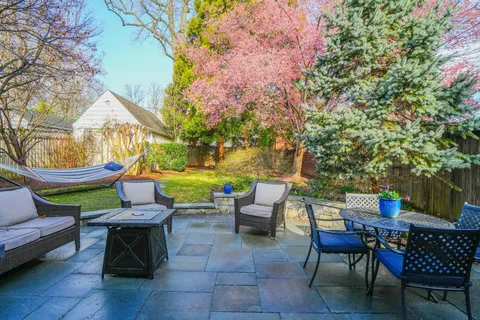 a view of a chairs and table in backyard of the house