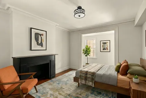 a bedroom with a bed and a couch