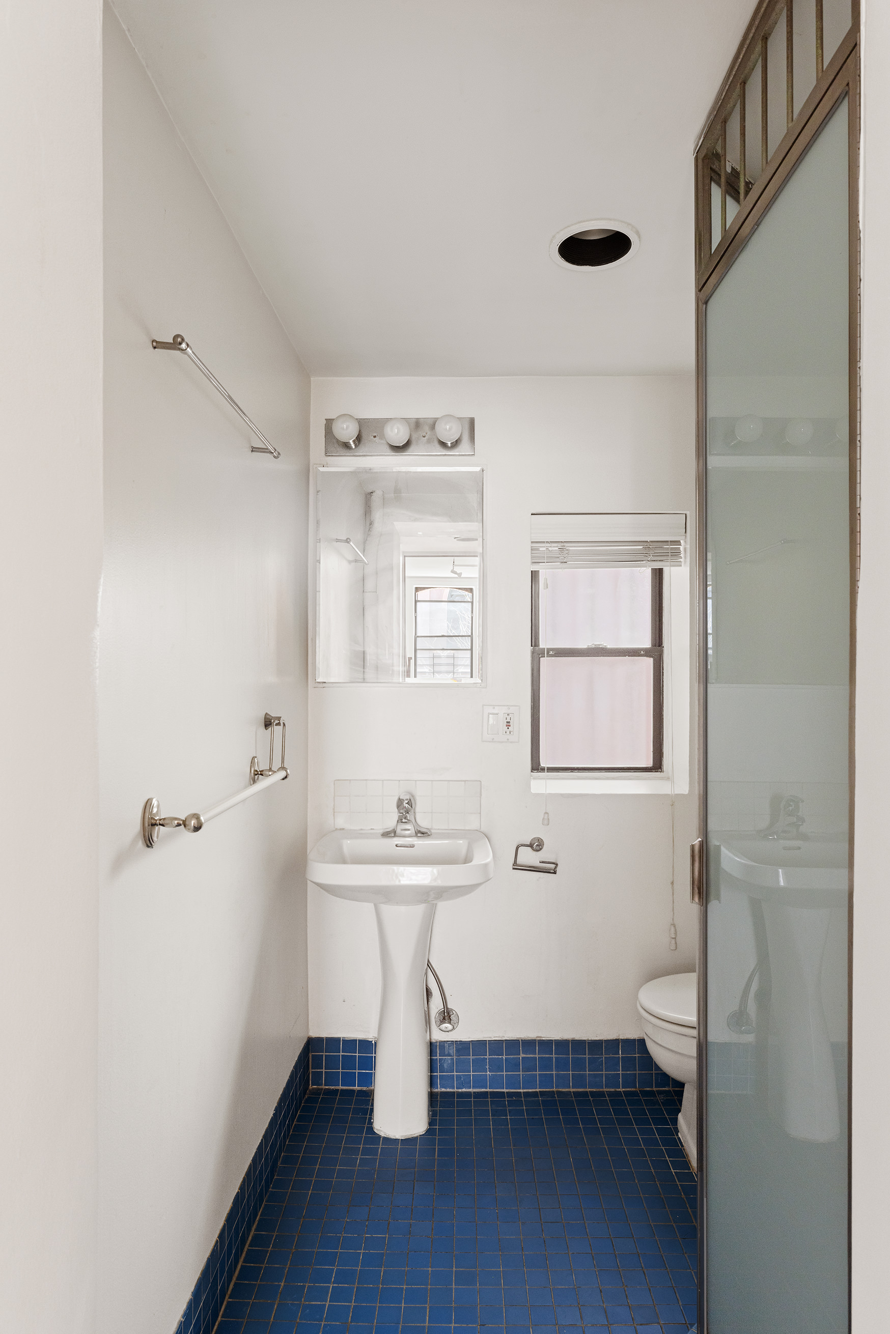 295 East 8th Street, Unit 2/3E Manhattan, NY 10009 - Photo 19 of 23 a bathroom with a sink a toilet and shower