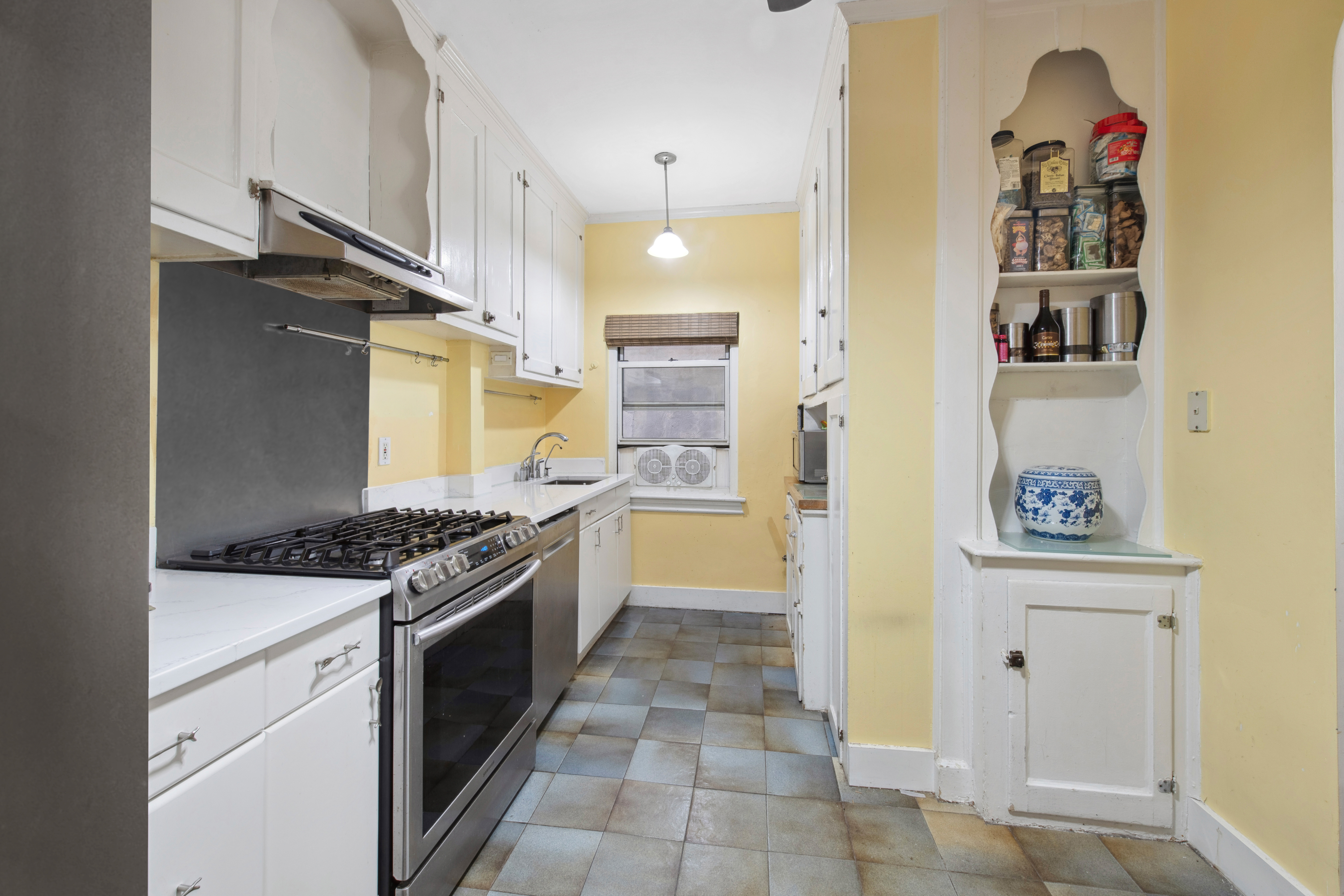 320 East 83rd Street, Unit 4DE Manhattan, NY 10028 - Photo 10 of 12 a kitchen with a stove and a refrigerator