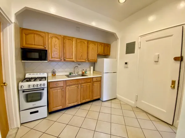 a kitchen with a stove a refrigerator and a sink