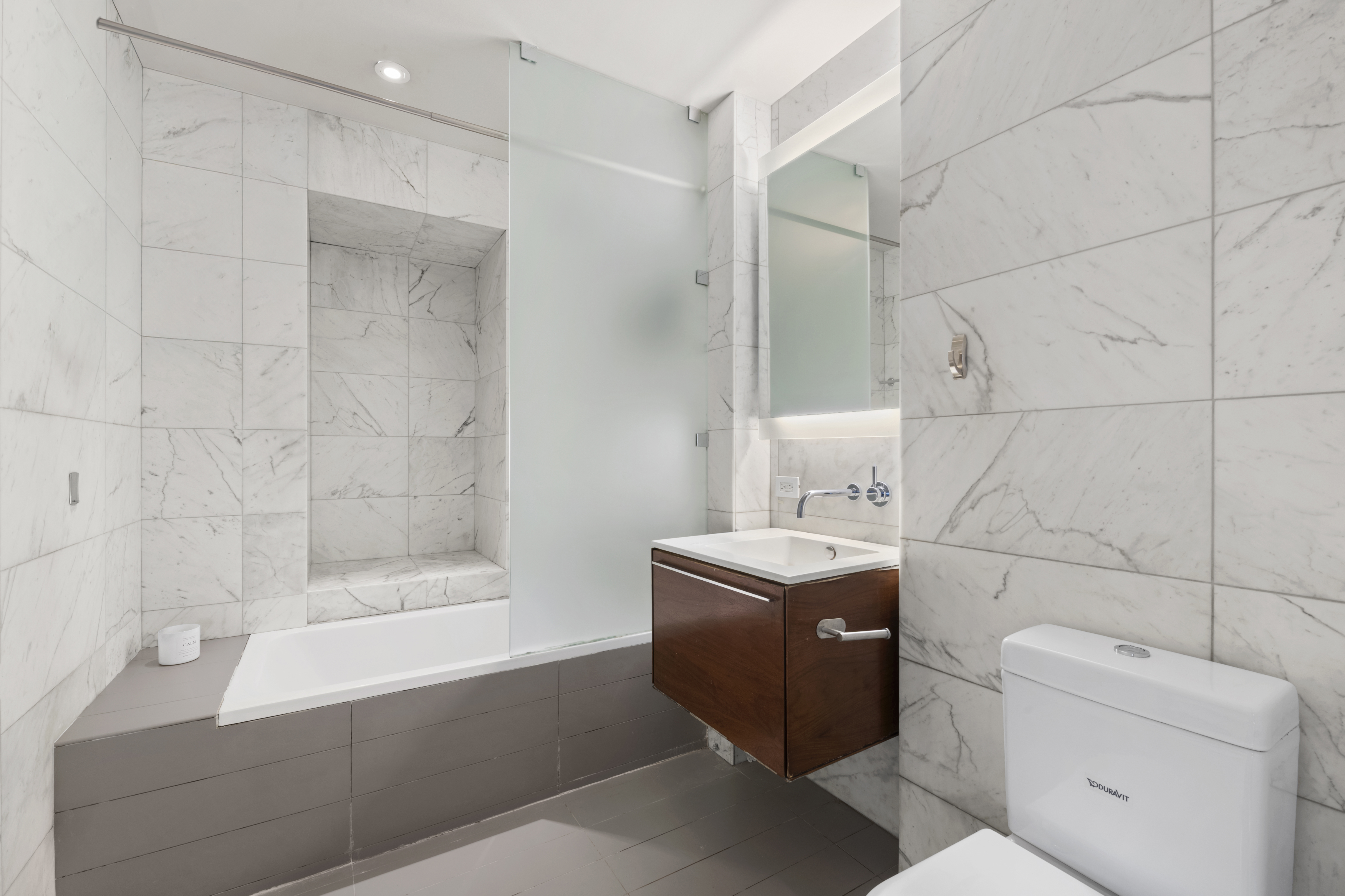 123 3rd Avenue, Unit 5D Manhattan, NY 10003 - Photo 6 of 12 a bathroom with a granite countertop sink a toilet and shower