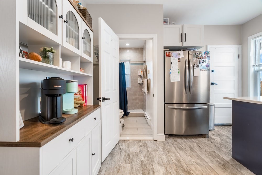 24 Buttonwood Street Boston, MA 02125 - Photo 5 of 43 a kitchen with stainless steel appliances granite countertop a refrigerator and a sink