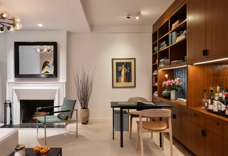 a living room with furniture a rug and a fireplace